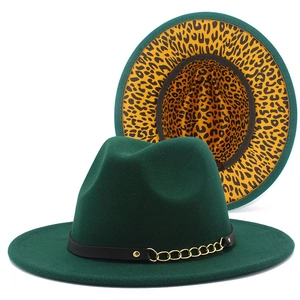 Detail of dark green wool fedora hat featuring metal chain and leopard print lining