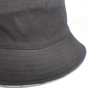 Close-up of black cotton twill bucket hat showing fine weave texture and reinforced stitching
