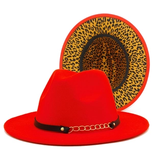 Detail of red fedora hat with gold chain accent and leopard print brim interior