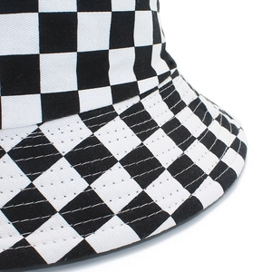 Detail of black and white checkerboard cotton bucket hat showing the reinforced stitching