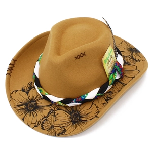 Detail of wool fedora hat with floral brim patterns, woven band and decorative feather