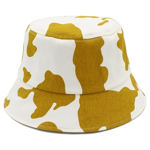 Mustard yellow and white cow print cotton bucket hat for sun protection outdoors