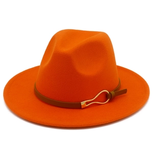 Detail of orange wide brim fedora hat with brown leather band and gold metal buckle