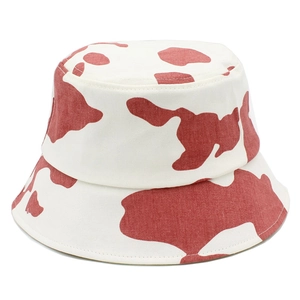 Detailed close-up of cotton fisherman hat featuring red cow print patterns and fine stitching