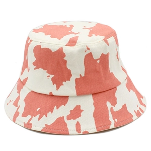 Pink and white cow print cotton bucket hat with a wide brim for sun protection