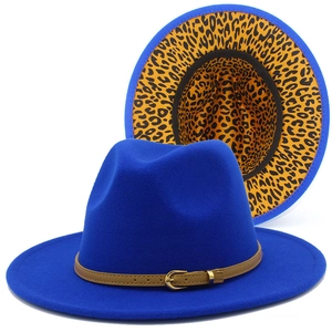 Detail of royal blue fedora hat with leopard print lining and brown leather band buckle