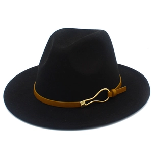 Detail of a black fedora hat featuring a mustard yellow band and gold metal buckle