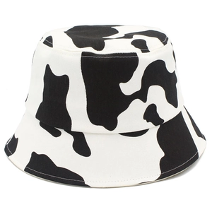 Close-up of black and white cow print pattern on a high-quality cotton bucket hat