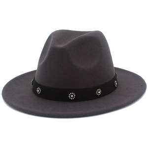 Detail view of dark grey fedora hat with black band featuring floral rhinestone buckles