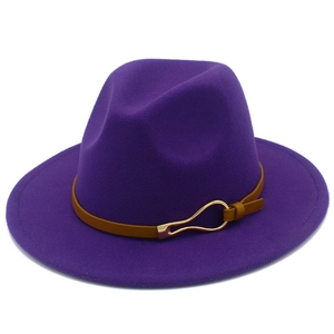 Detail shot of a dark purple wool fedora hat featuring a brown leather band and gold buckle