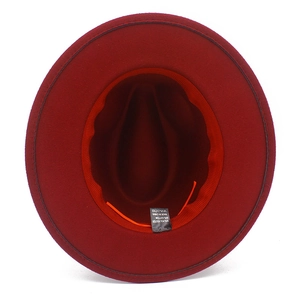 Detail view of the interior orange adjustable drawstring and washing label of the red jazz hat