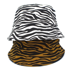 Detail view of cotton bucket hats featuring black-white and brown zebra animal prints