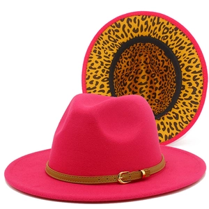 Detail of rose red fedora hat with brown leather band and leopard print lining inside