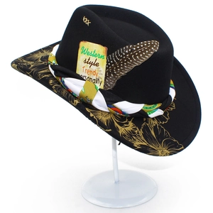 Detail of wool fedora featuring gold floral prints, woven band and decorative feather