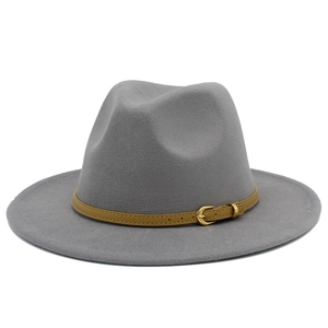 Detail of grey felt fedora hat featuring a camel leather band and golden metal buckle