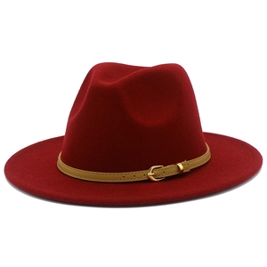 Detailed close-up of a burgundy fedora hat featuring a beige leather strap and gold buckle