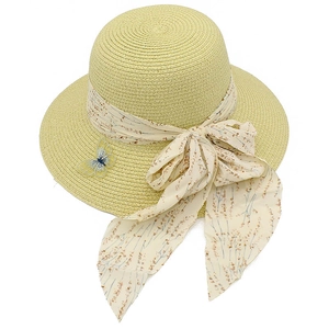 Detailed close-up of straw sun hat with floral ribbon bow and embroidered butterfly patch