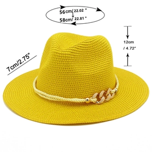 Detail of yellow straw sun hat showing dimensions, braid texture and gold chain trim