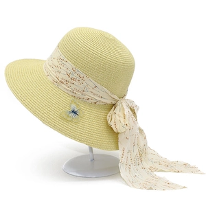 Women's woven sun hat with floral ribbon bow and butterfly appliqué on display stand
