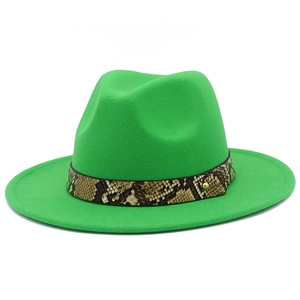 Close-up of emerald green fedora hat featuring snake skin band and gold rivet detail