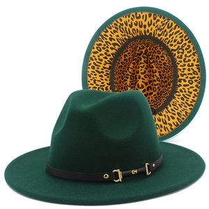 Macro detail of the leopard print lining and gold horsebit buckle on a green wool fedora hat