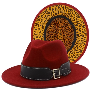 Detail of burgundy fedora hat showing leopard print lining and black leather belt buckle