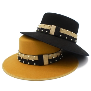 Close-up of wool fedora hats with pearl and rhinestone bands in black and yellow