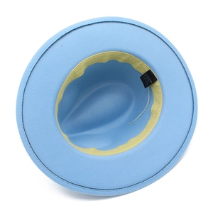 Detail view of light blue fedora showing yellow sweatband and material content label