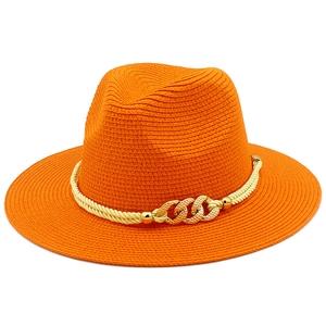 Detail of orange woven straw hat with cream rope trim and gold chain link hardware
