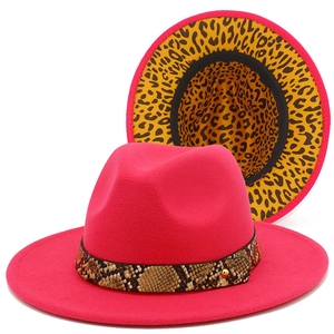 Detail of rose red fedora hat featuring snakeskin band and leopard print lining