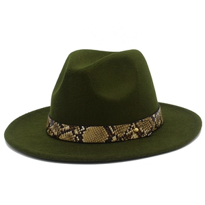 Close-up of olive green fedora hat featuring a brown snakeskin band and gold metal rivet