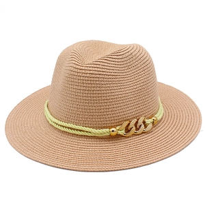 Detail of woven straw sun hat featuring yellow rope and gold chain link decoration