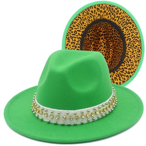 Detail of green wool fedora hat with studded band and leopard print inner lining