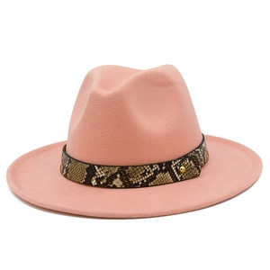 Close-up of pink wide brim wool fedora with snakeskin leather belt and gold stud