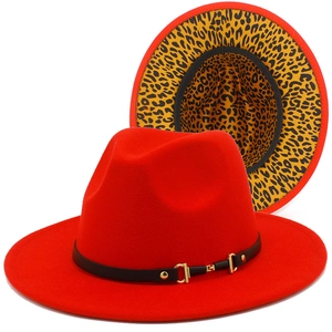 Detail of red fedora hat featuring a leopard print underbrim and black leather band