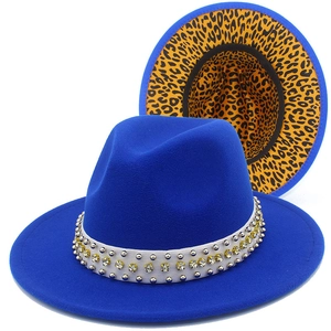 Detail view of royal blue fedora hat featuring studded trim and leopard print lining