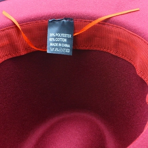 Detail of wool-like fedora interior showing 65% cotton blend label and adjustable drawstring