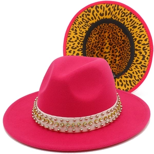 Detail of rose red fedora with pearl rivets and vibrant leopard print brim lining