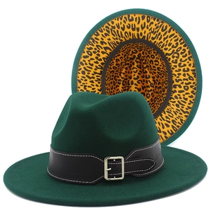 Detail view of dark green fedora hat featuring black leather band and leopard print lining
