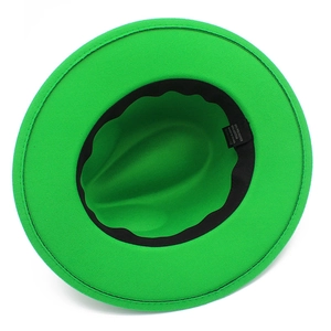 Detail view of the interior lining, sweatband and material label of a green wool fedora hat