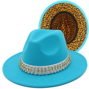 Detailed view of teal fedora hat with leopard print lining and rhinestone studded band