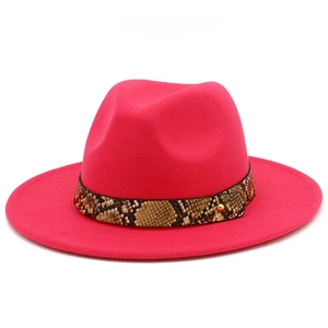Detailed view of rose pink fedora hat featuring a snakeskin pattern leather band and gold stud