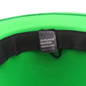 Detailed close-up of the green felt hat interior with 65% cotton fabric label and sweatband