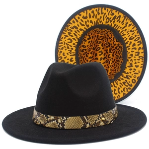 Detail of black fedora hat with snake print band and leopard lining inside