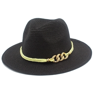 Detail of black straw fedora hat featuring yellow woven band and gold chain links