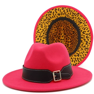 Detail of fuchsia fedora hat showing leopard print lining and black belt with buckle