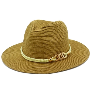 Detail of classic straw fedora with fine spiral texture and gold chain link buckle
