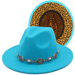 Detail of turquoise fedora hat with leopard print brim and metallic chain band