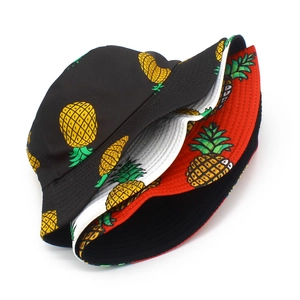 Detail of reinforced stitching on brim and vibrant pineapple print on cotton bucket hats
