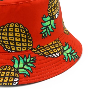 Close-up of red cotton bucket hat featuring colorful pineapple embroidery and precise brim stitching